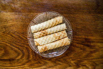 Bakery ingredients - bread, wafer rolls on wood table. Sweet pastry baking concept. Flat lay, copy space, top view. Organic food.