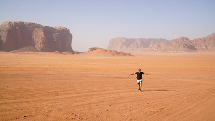Fototapeta na wymiar Dry orange desert landscapes in Wadi Rum, Jordan.