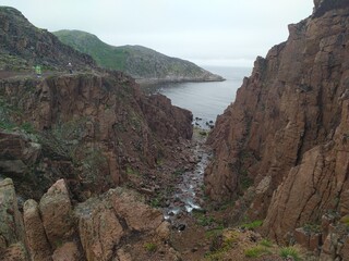 High cliffs and waterfalls on the coast of the Barents sea Arctic ocean