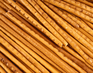 Creative layout made of crackers sticks on the white background. Food concept. Edible snack dry sticks with salt on white background. Straws, sticks crackers.