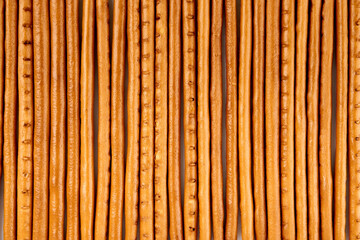 Creative layout made of crackers sticks on the white background. Food concept. Edible snack dry sticks with salt on white background. Straws, sticks crackers.