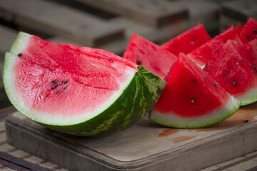 Fresh red watermelon on wooden cutting board, picnic concept, selective focus