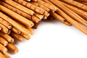 Creative layout made of crackers sticks on the white background. Food concept. Edible snack dry sticks with salt on white background. Straws, sticks crackers.