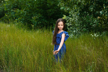 Pretty little girl relaxing outdoors on  summer vacation.