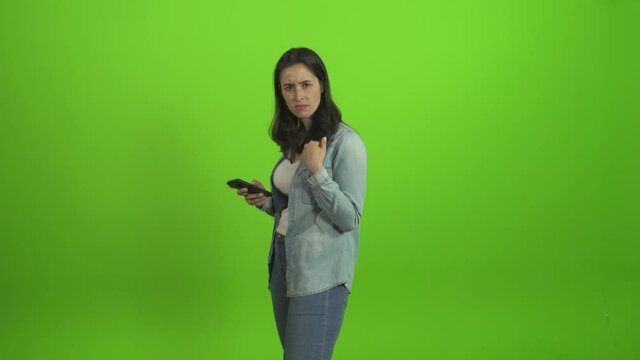 woman  on her mobile pointing herself and say who me, not me  over green screen
