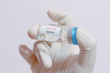 Vaccine COVID-19 (Coronavirus) glass bottle in medical doctor hand