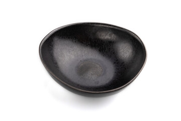 Empty black ceramic bowl isolated on white background. Side view, close up.