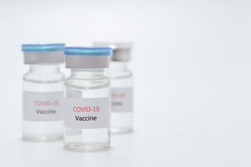 Vaccine COVID-19 (Coronavirus) in glass bottle on white