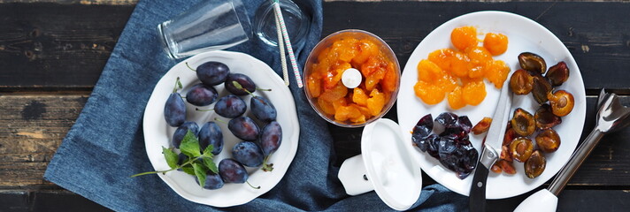 Blue ripe plum on a dark background. The process of making cream juice from natural plums or smoothie using a mixer.