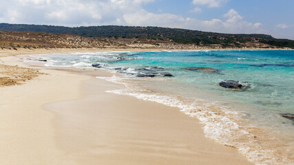 View of crystal clear blue water with white sand ,small waves, holiday Cyprus background in Dipkarpaz village 