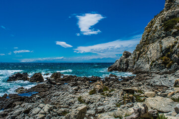 rocky coast in italy with blue sky