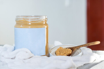Delicious handmade peanut butter unlabeled on a white background. Superfood. Spreads