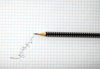 Black pencil on a piece of writing paper.