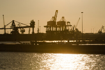 Fototapeta na wymiar cranes on the docks in the sunset