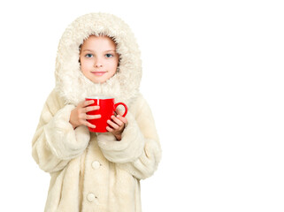 Smiling little girl in winter clothes with a red cup of hot drink.