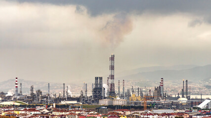 Obraz na płótnie Canvas Oil refinery factory on the sea in Izmit, Turkey. Petrochemical plant structure on manufacturing oil refinery. Tupras Izmit petroleum refinery. Tupras is Turkey's largest oil refinery.