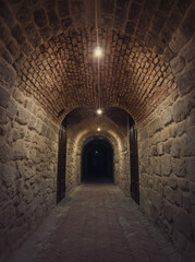 Old wine cellar tunnel at the Hincesti winery underground of the Manuc Bei mansion in Moldova. Traditional moldavian rural subterrane stone vault reconstructed with modern motif. Creepy dark details.