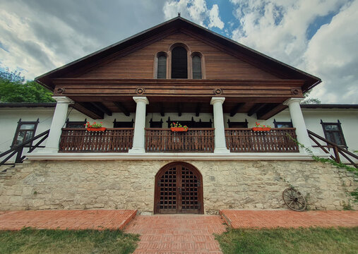 The Museum house facade at Manuc Bei mansion, architectural, culture and historic complex of Hincesti city, Moldova. Old, traditional moldavian rural home with porch on pillars, stone and wood details