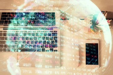 Business theme hologram drawings over computer on the desktop background. Top view. Multi exposure. Concept of international connections.