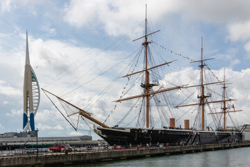 The Spinnaker Tower and HMS warrior side by side in Portsmouth Dockyard