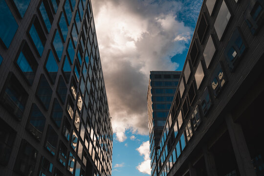 Upwards angle look up shot of big modern building with sky reflection on the windows