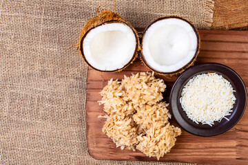 Cocada on the wooden table. Traditional coconut sweet from Brazil.