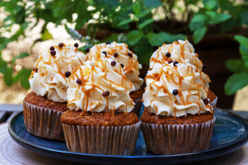 Carrot cupcakes with mascarpone cream and grated walnuts