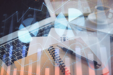 Double exposure of financial chart drawing and desktop with coffee and items on table background. Concept of forex market trading