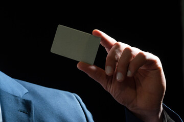 Hand holds a credit card.