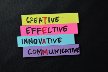 TEAM - Creative Effective Innovative Communicative write on sticky notes isolated on office desk.