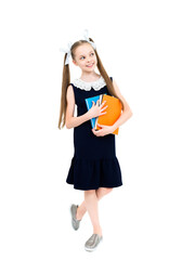 Happy cute smiling cheerful child girl in school uniform holding books.