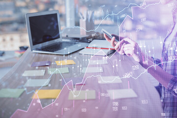 Double exposure of woman hands working on computer and forex graph hologram drawing. Financial analysis concept.