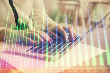 Multi exposure of woman hands typing on computer and financial graph hologram drawing. Stock market analysis concept.