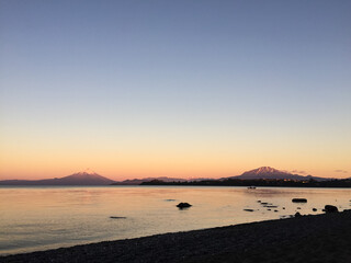Sunset over Llanquihue Lake in the south of Chile with view of Osorno and Calbuco volcanoes