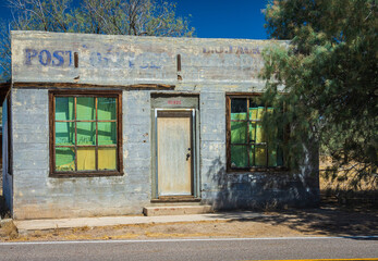 old abandoned building once used a post office in desert village