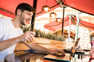Young man using laptop skype video chat.