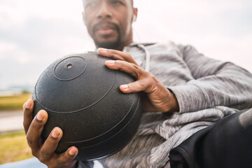 Athletic man doing exercise with medicine ball.
