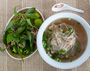 Vietnamese Pho in White Bowl on Beige Table Cloth