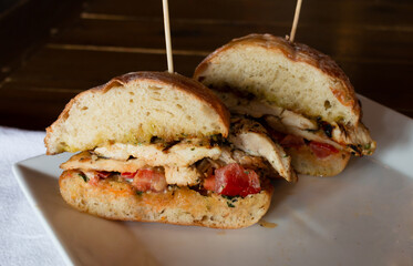  Chicken Sandwich on White Plate with Napkin and Wood Background