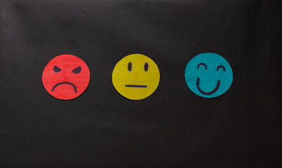 Hand choosing green paper cut happy smile face, feedback rating and positive customer review,...