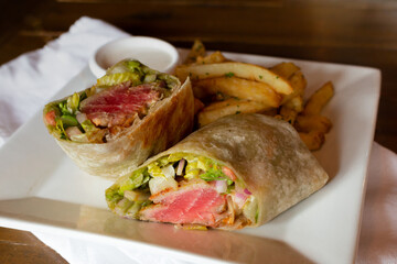 Ahi Tuna Wrap on White Plate with Napkin and Wood Background