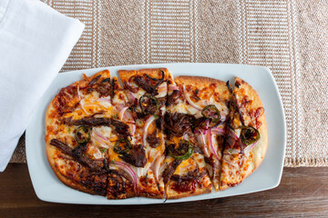  BBQ Pizza on White Plate with Napkin and Wood Background