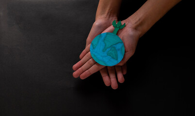 Hands holding growing tree on earth, save planet, earth day, world environment day, eco environment, climate emergency action, csr social responsibility, sustainable life concept