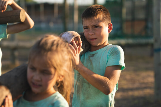 Boy carrying a log at a boot camp