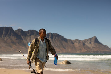 Disabled Black African American  male athlete walking with a bottle