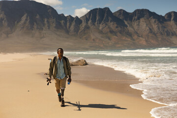 Disabled Black African American  male athlete walking near water