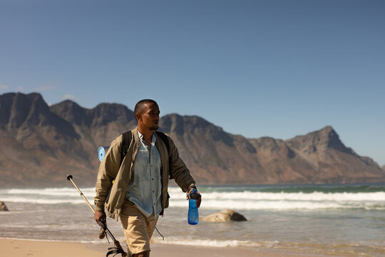 Disabled Black African American  male athlete walking with a bottle