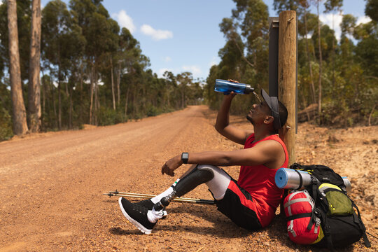 Disabled Black African American male athlete siting and pouring water
