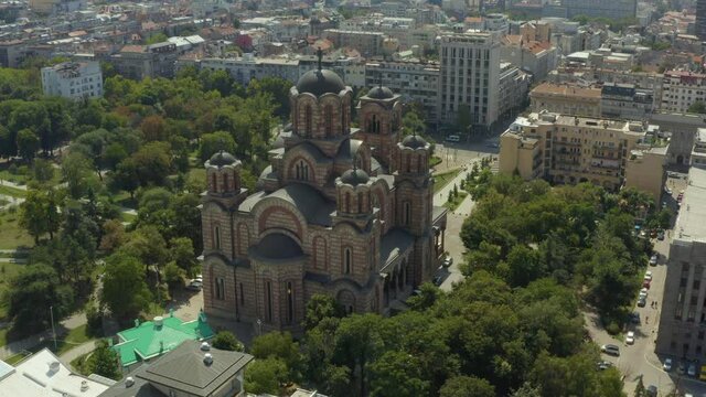 Aerial shot Belgrade Serbia. drone flight over the red church in the city center which is surrounded by a park. beautiful landscape.