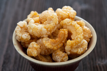 Homemade deep fried crispy pork rind in bowl.